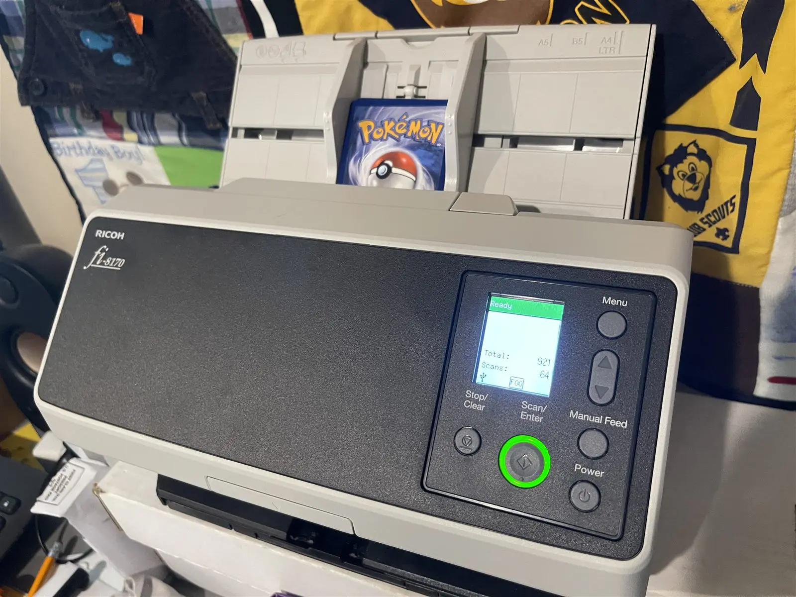 The card scanner with a Pokemon card loaded in the feeder
