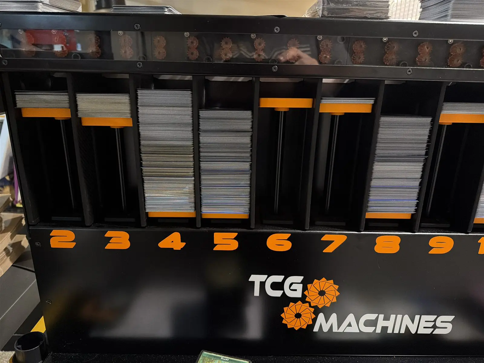 The front of the sorting machine, with Pokemon cards sorted into numbered bins