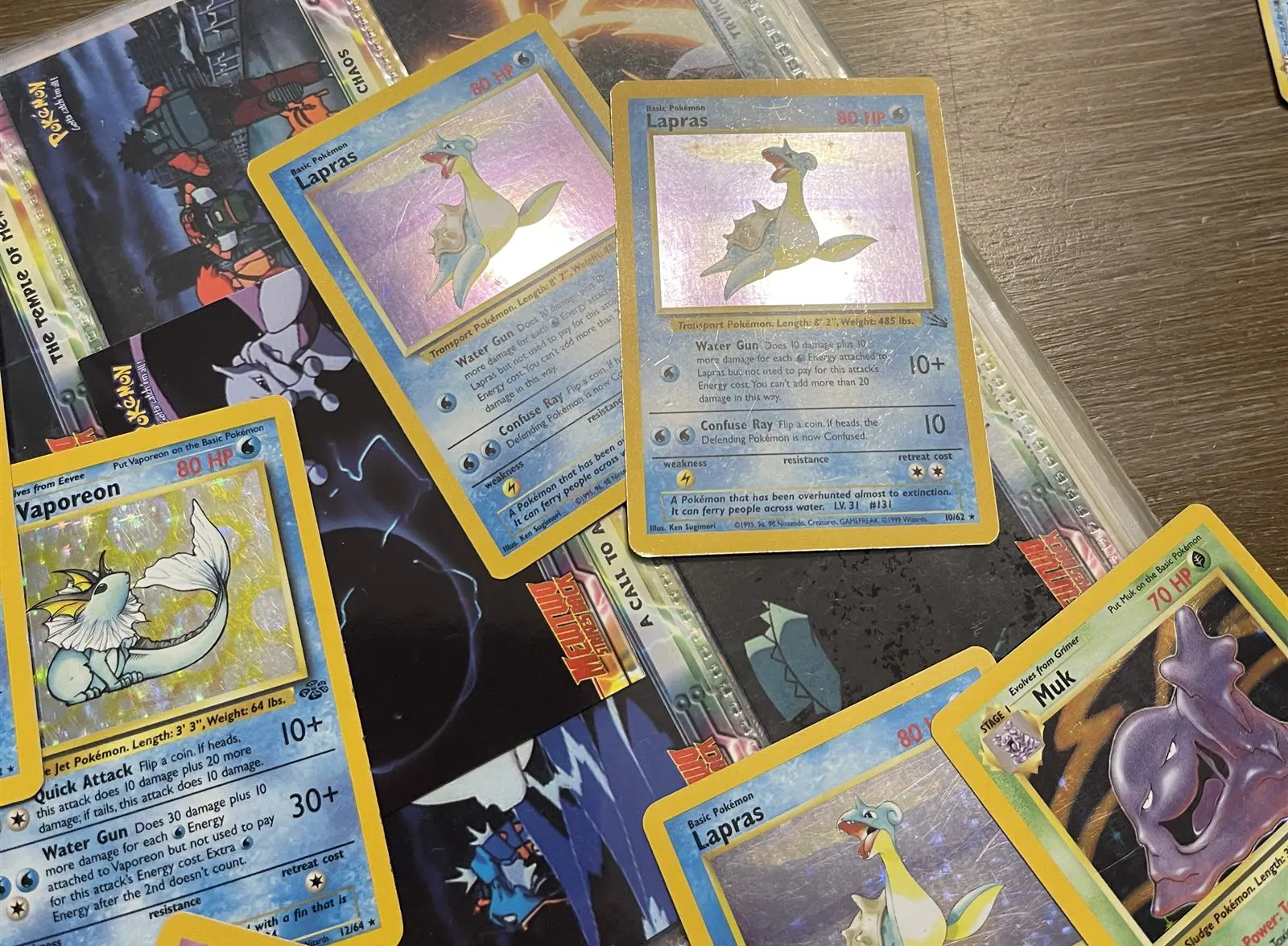 Older Wizards-era Pokemon cards, including holo Lapras and Vaporeon, in good condition