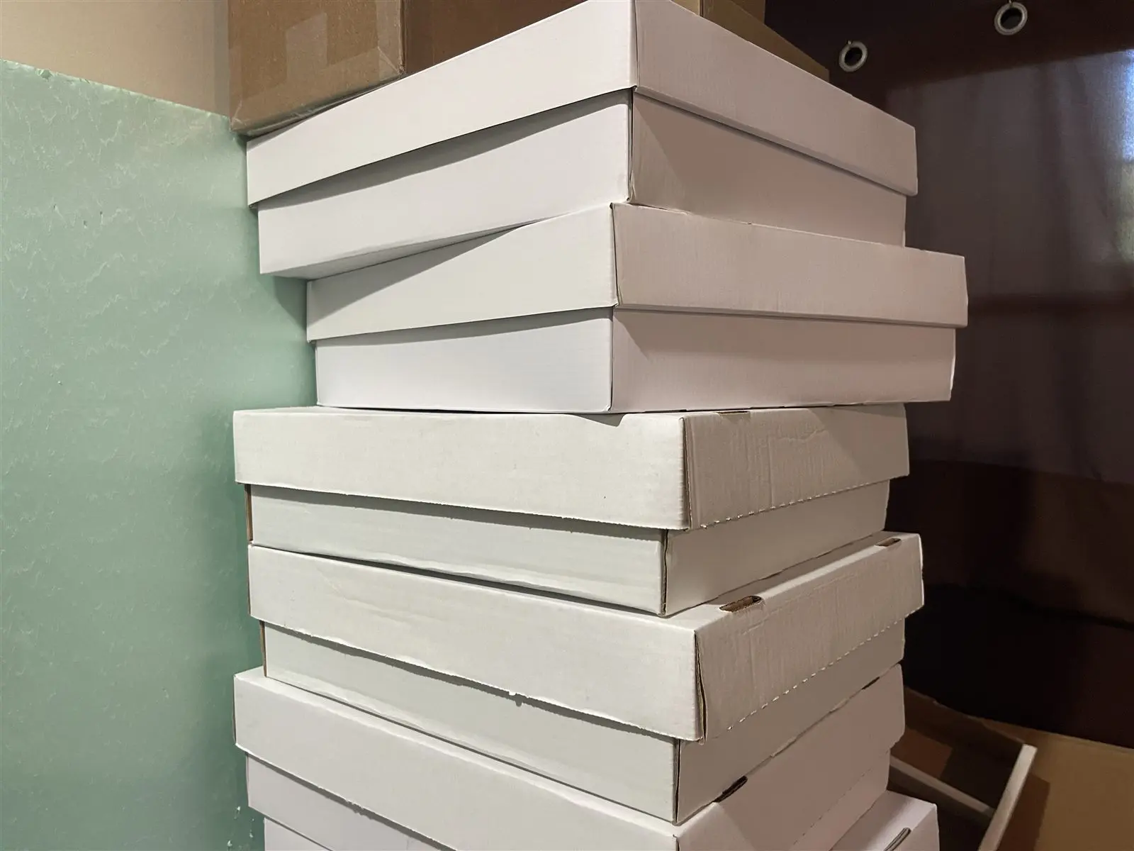 A tall stack of white boxes full of sorted cards